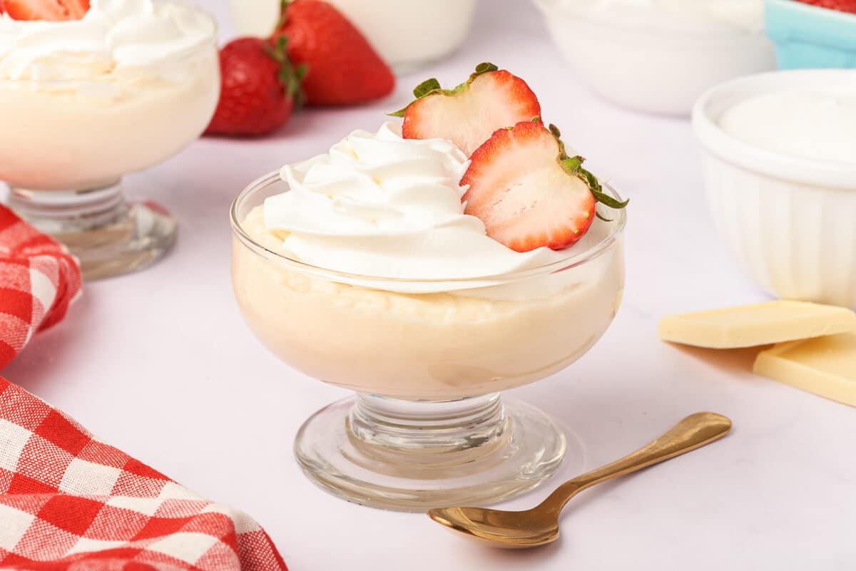 A parfait dish of white chocolate pudding.