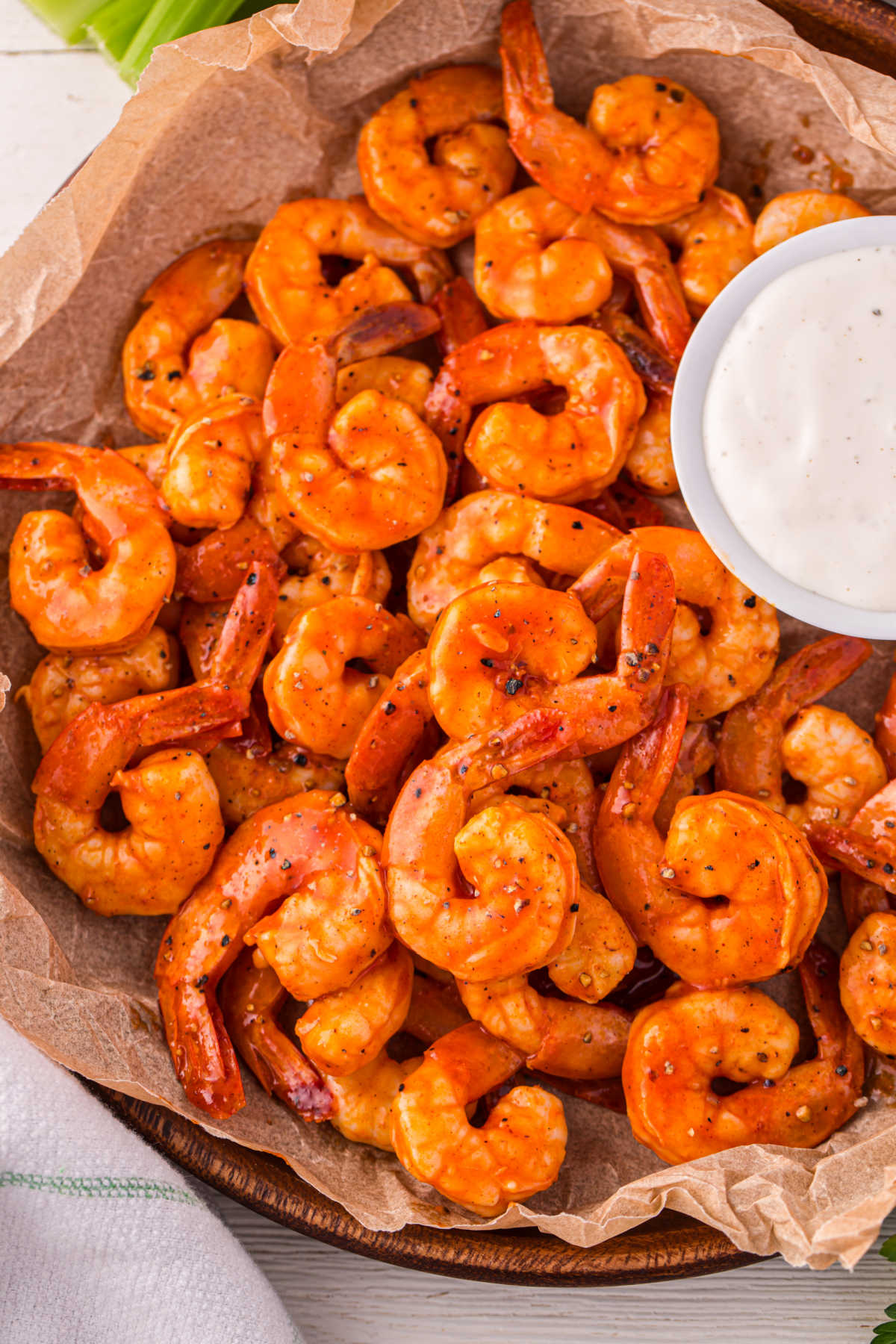 Buffalo shrimp in a basket with ranch dressing.