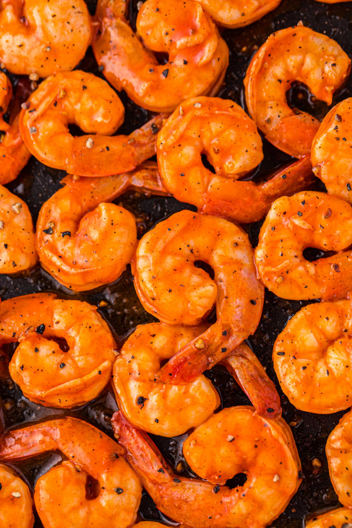 Buffalo shrimp on a baking sheet.