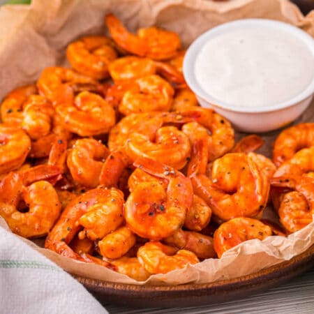 Buffalo shrimp in a bowl with ranch dipping sauce.