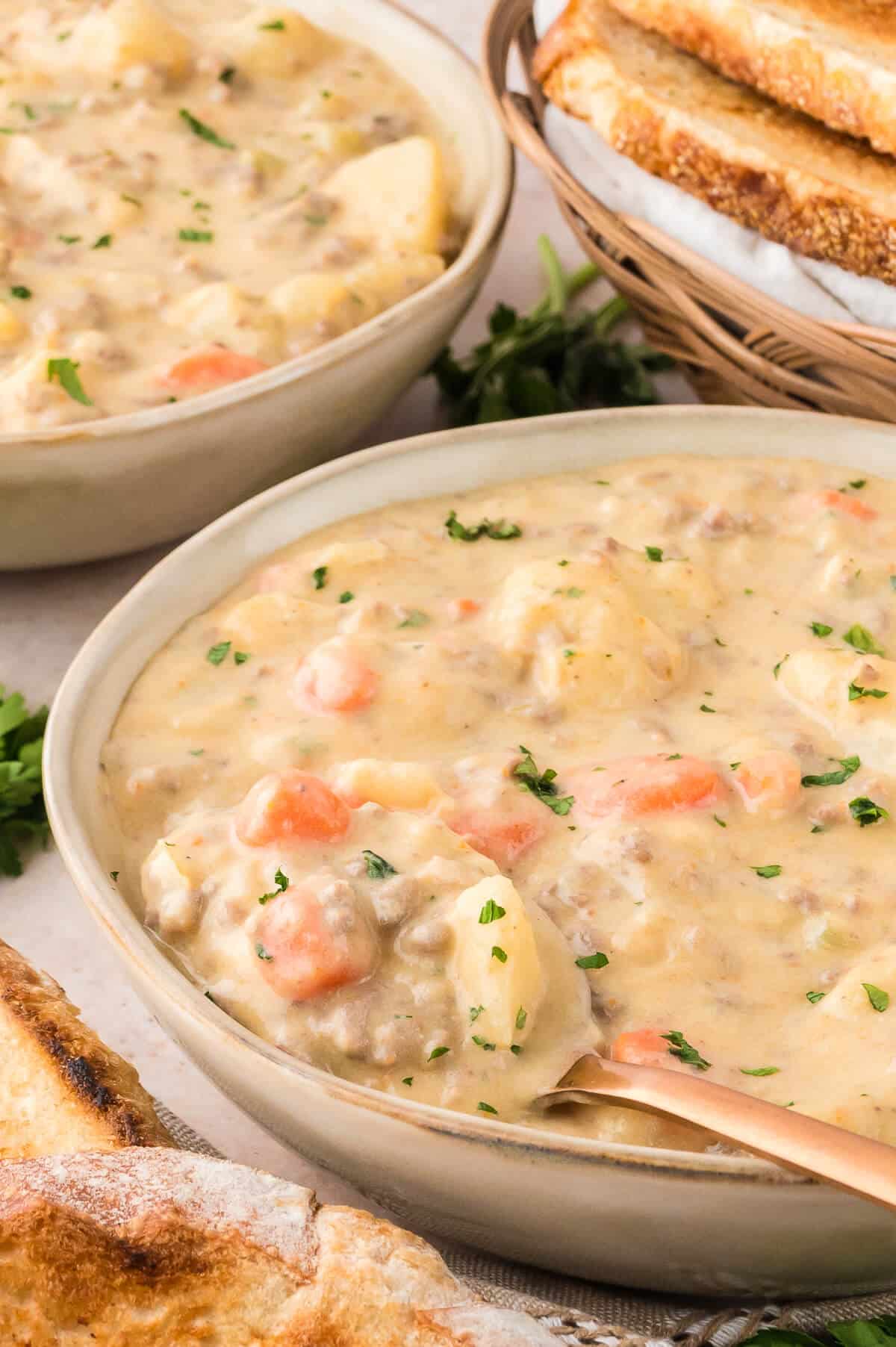 Cheeseburger Chowder in a bowl with a spoon.