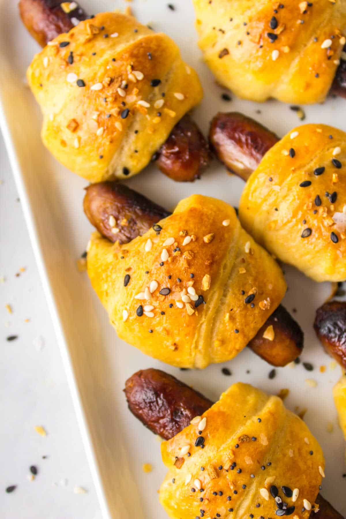 Breakfast pigs in a blanket on a platter.