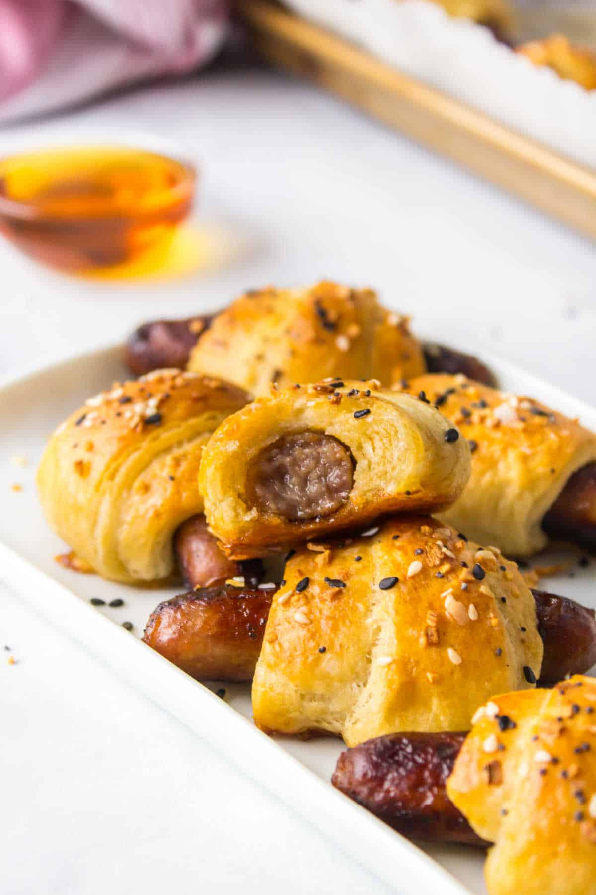 Breakfast pigs in a blanket on a platter.