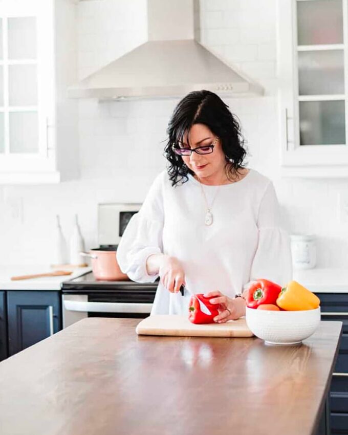 Stacie, author of Simply Stacie, standing in kitchen.