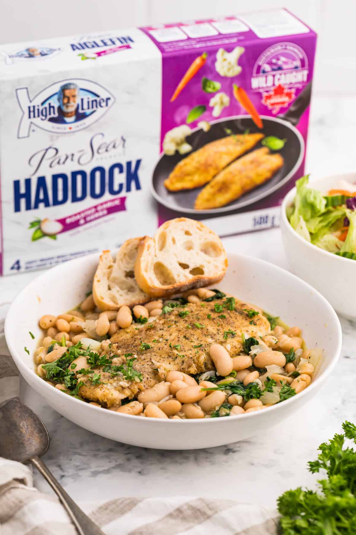 A bowl of haddock with spinach and white bean ragout.