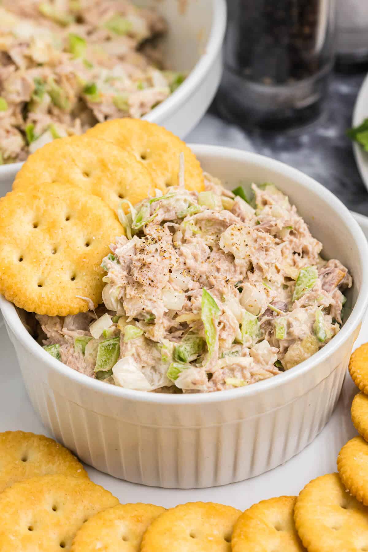 Tuna salad in a bowl with crackers.