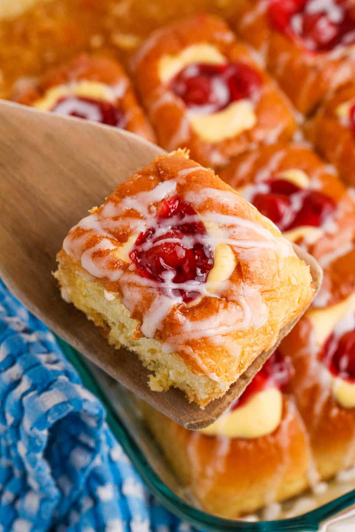 Cherry Hawaiian Danish on a wooden serving spoon.