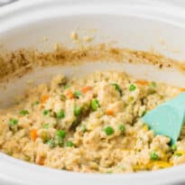 The recipe in a crockpot with a wooden spoon.