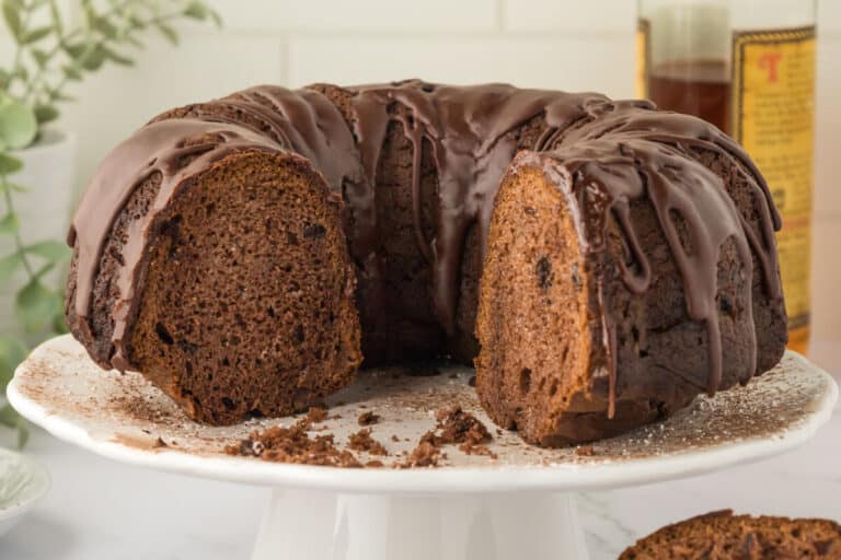Cake on a plate with a slice removed.