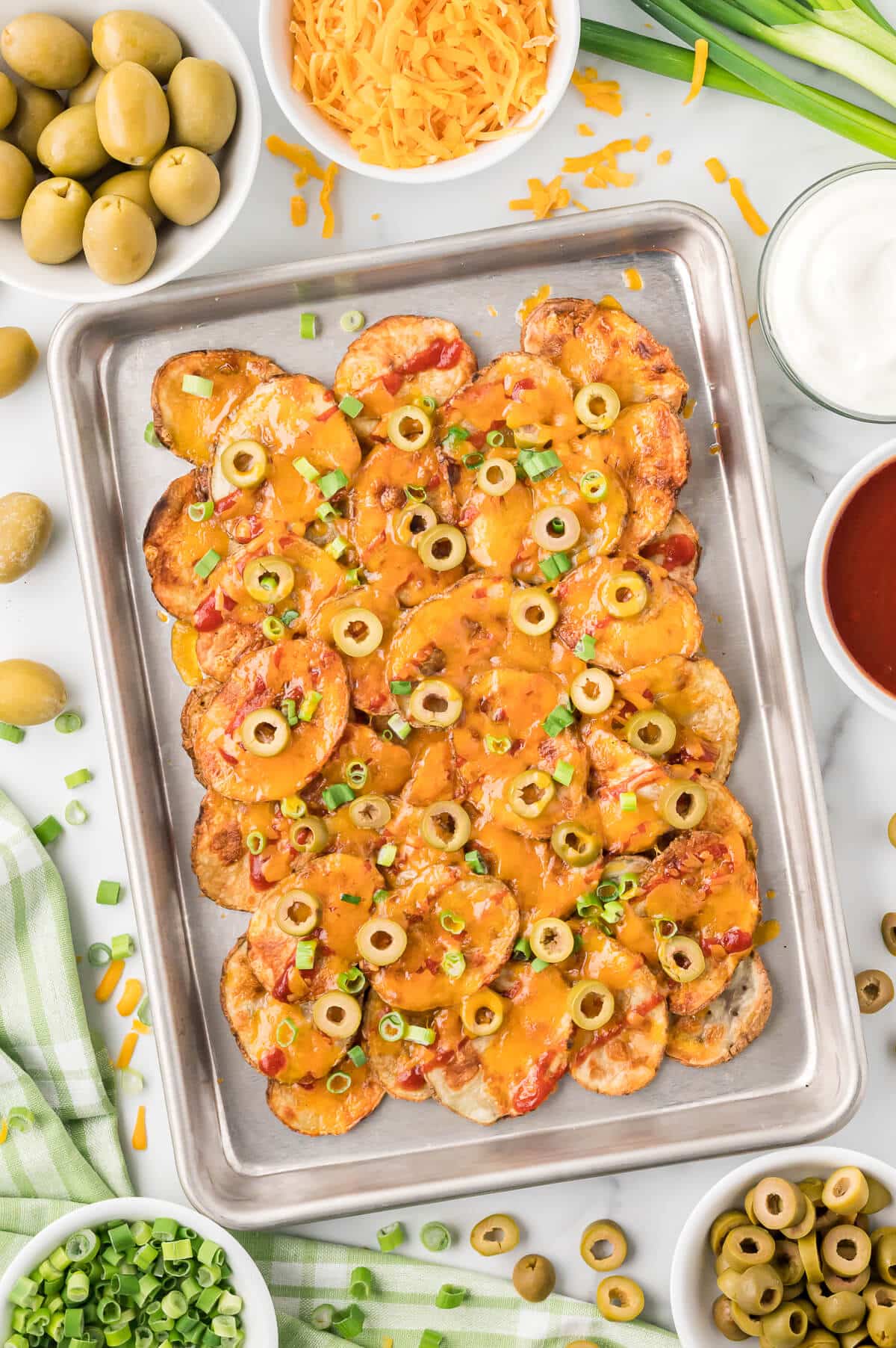 Potato nachos on a baking pan.