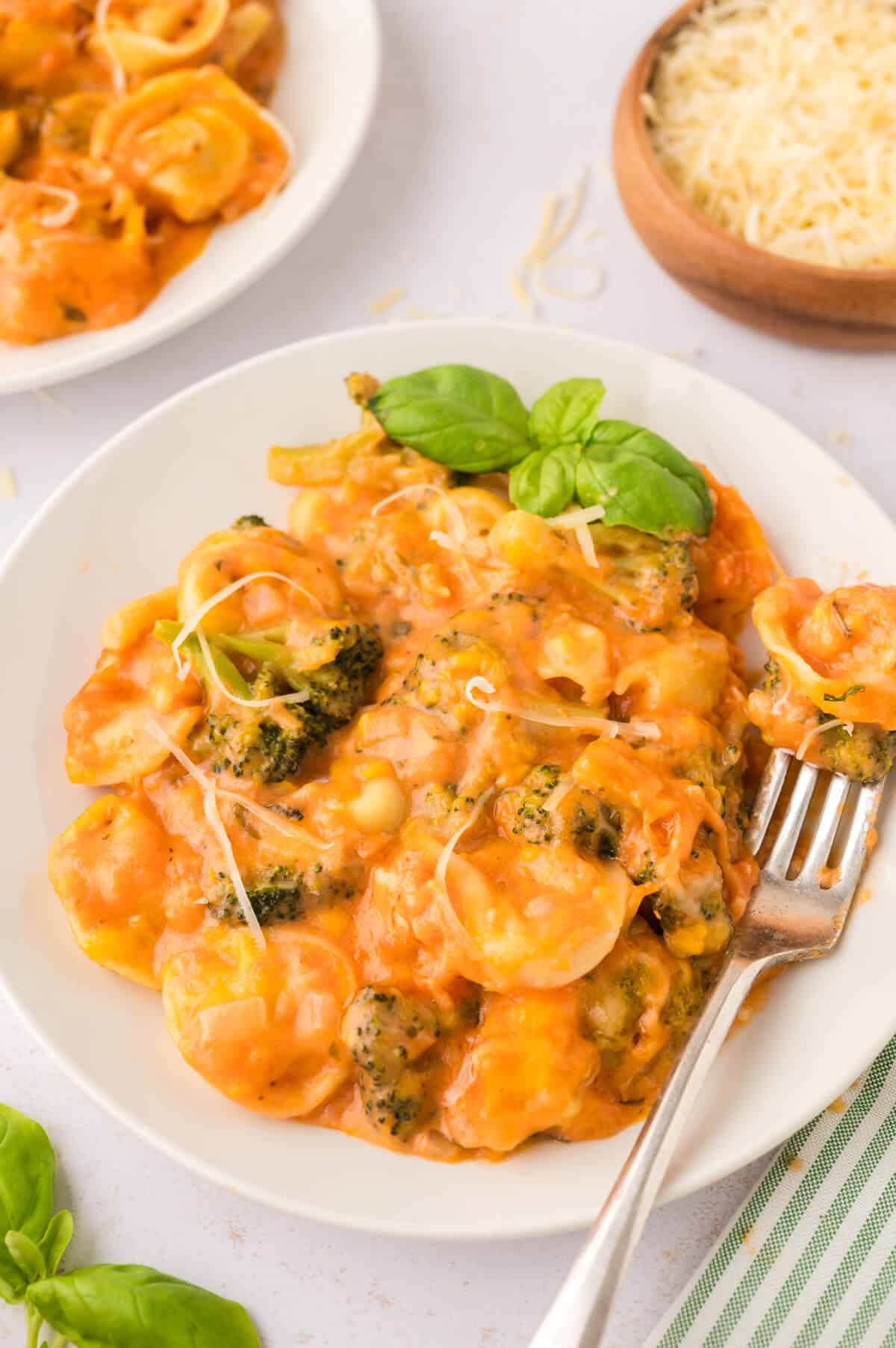 Tortellini casserole on a plate with a fork.