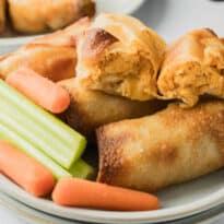 The recipe on a plate with carrot and celery sticks.