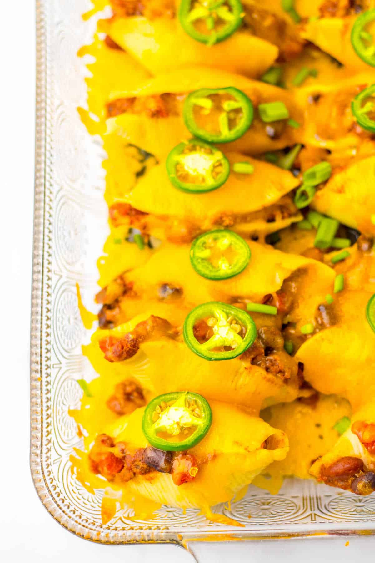 Chili cheese stuffed shells in a pan.