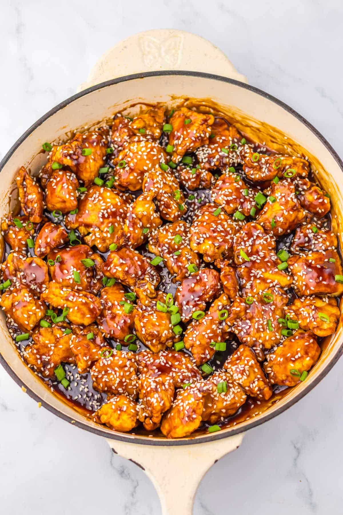 Honey sesame chicken in a pan.