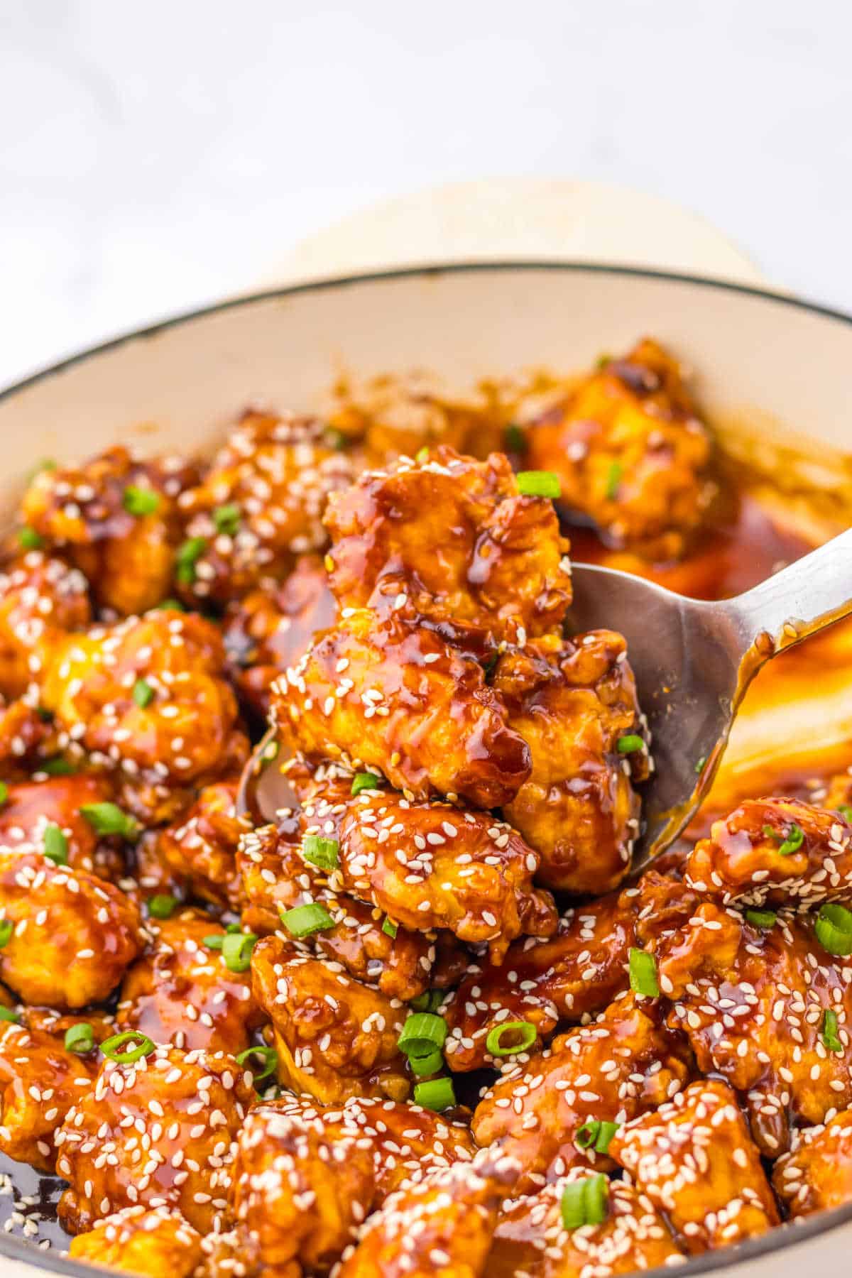 The recipe in a pan with a serving spoon.