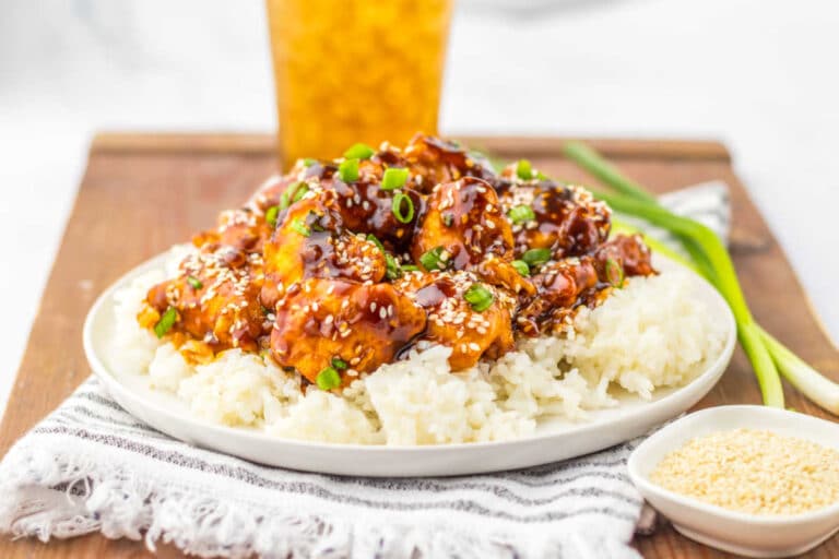 The recipe on a bed of rice on a plate.