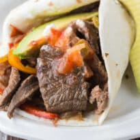 Slow cooker steak fajitas on a plate.