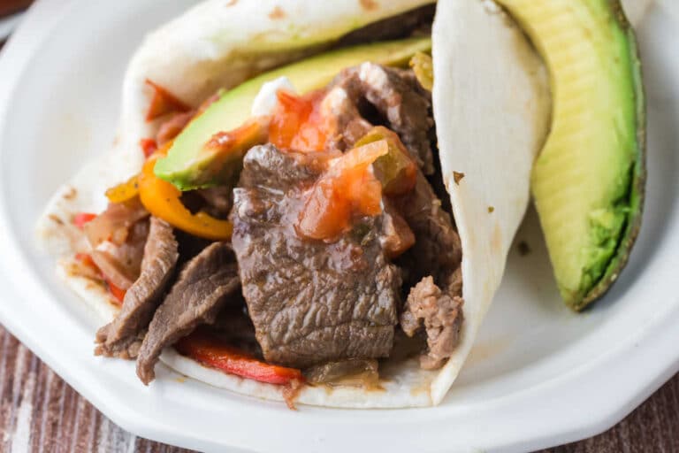 Slow cooker steak fajitas on a plate.