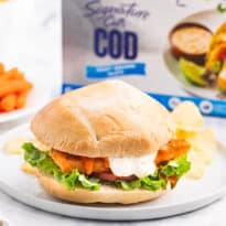 A buffalo cod filet sandwich on a plate.