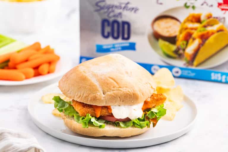 A buffalo cod filet sandwich on a plate.