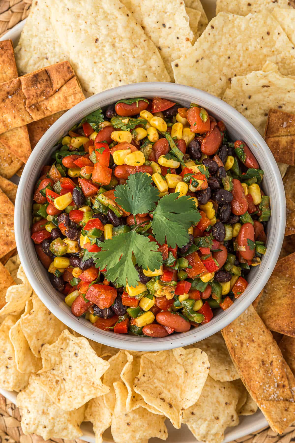 Cowboy caviar in a bowl surrounded by chips.