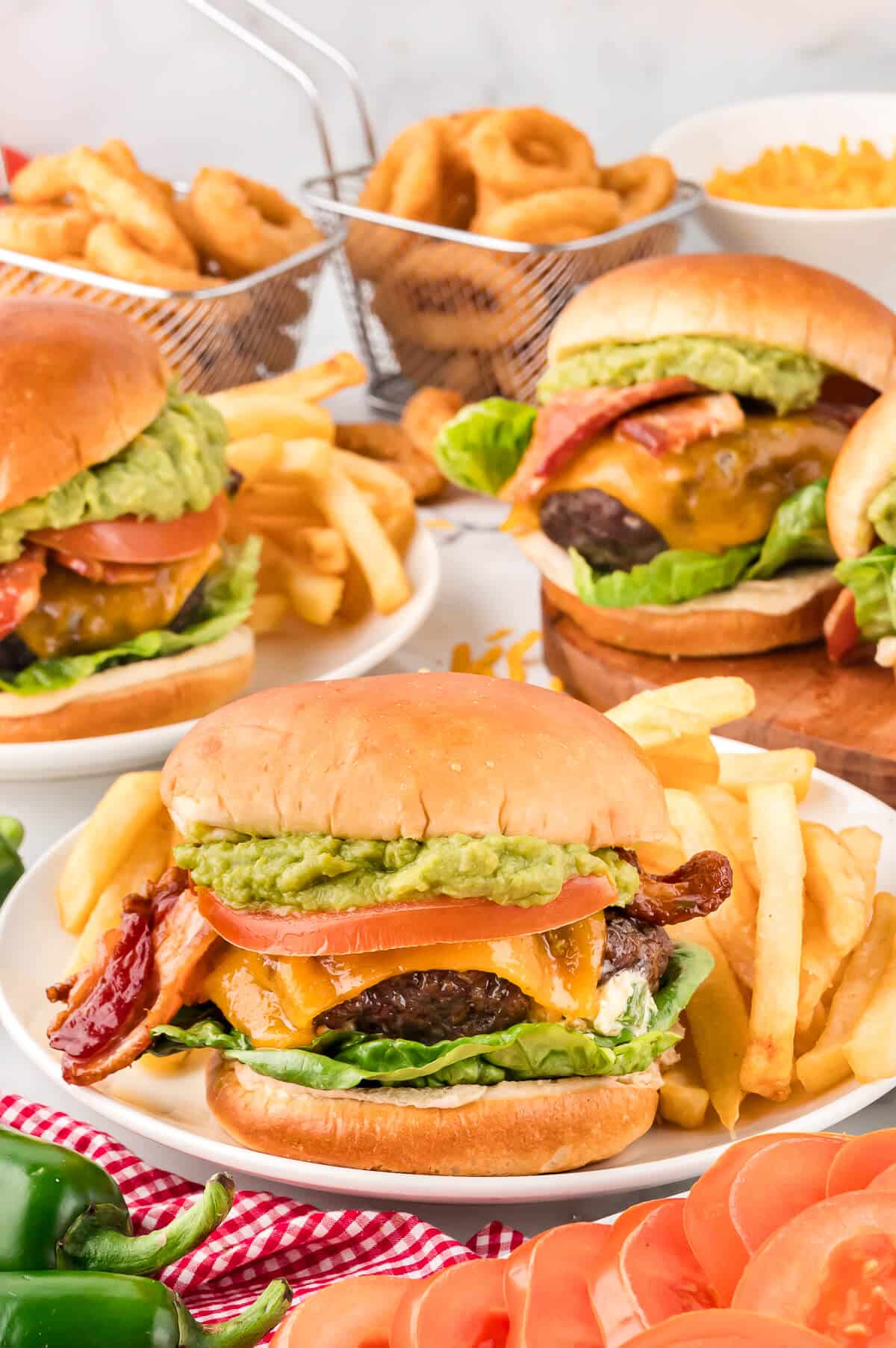 Cream cheese stuffed jalapeno burger on a plate with fries.