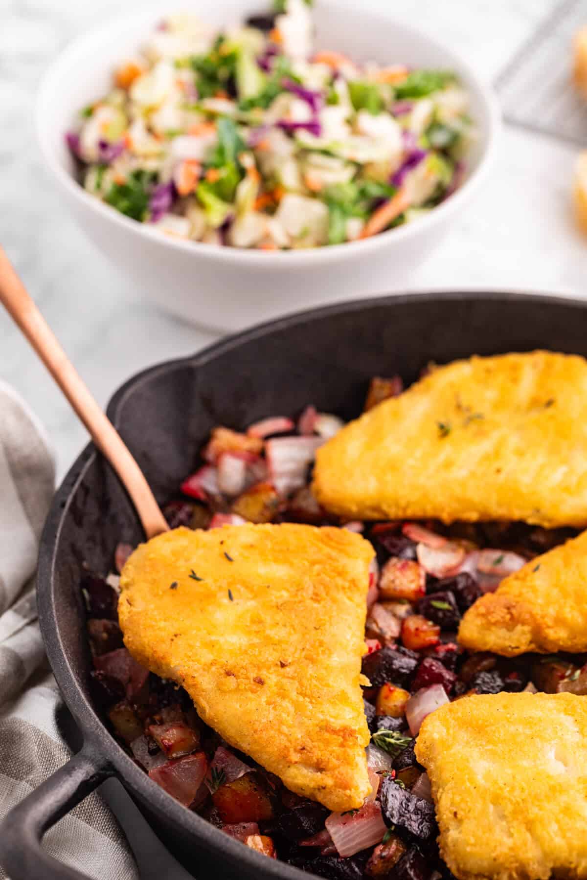 Fish with Beet and Potato Hash in a pan with a serving pan.