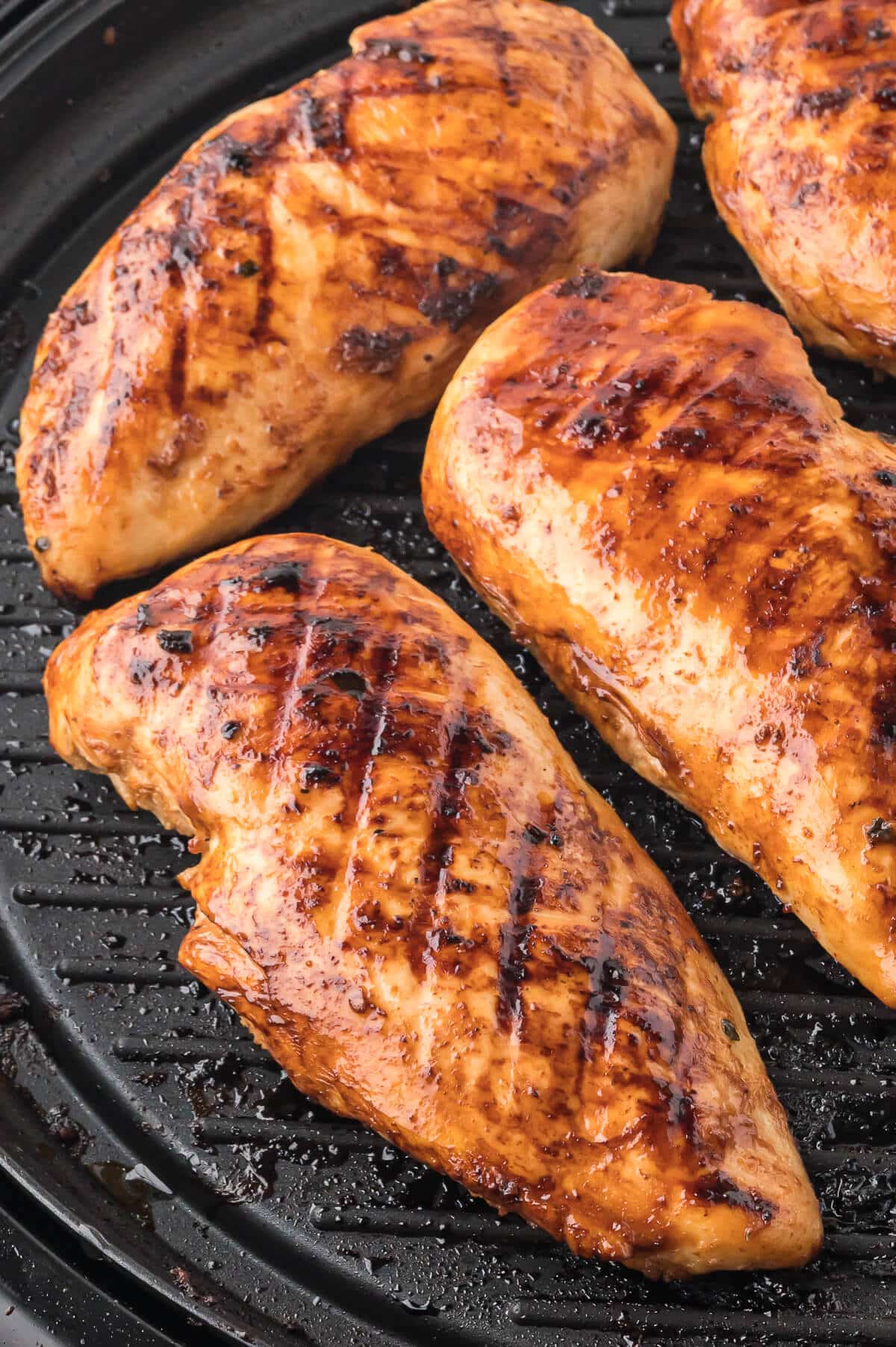 Grilled honey dijon chicken on a grill.