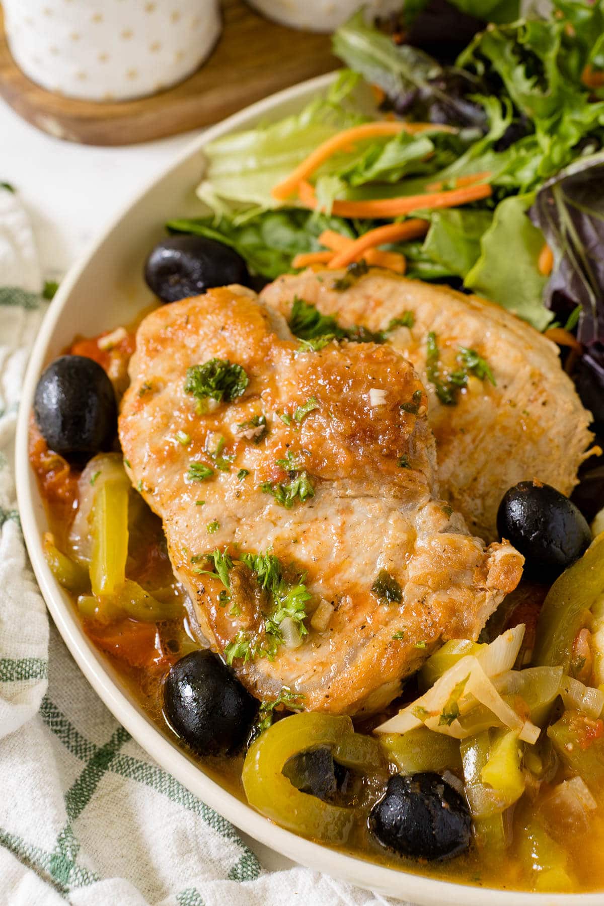 Savory pork chops on a plate with salad.