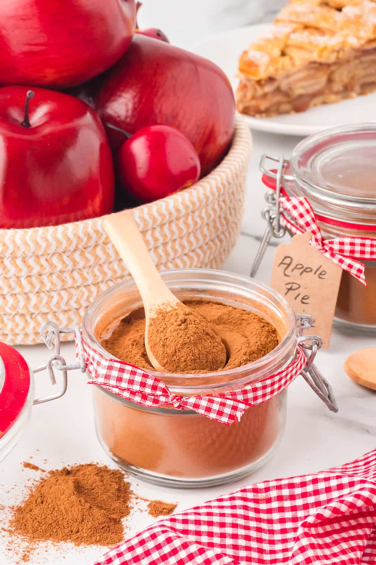 The spice in a decorative jar with a wooden spoon.