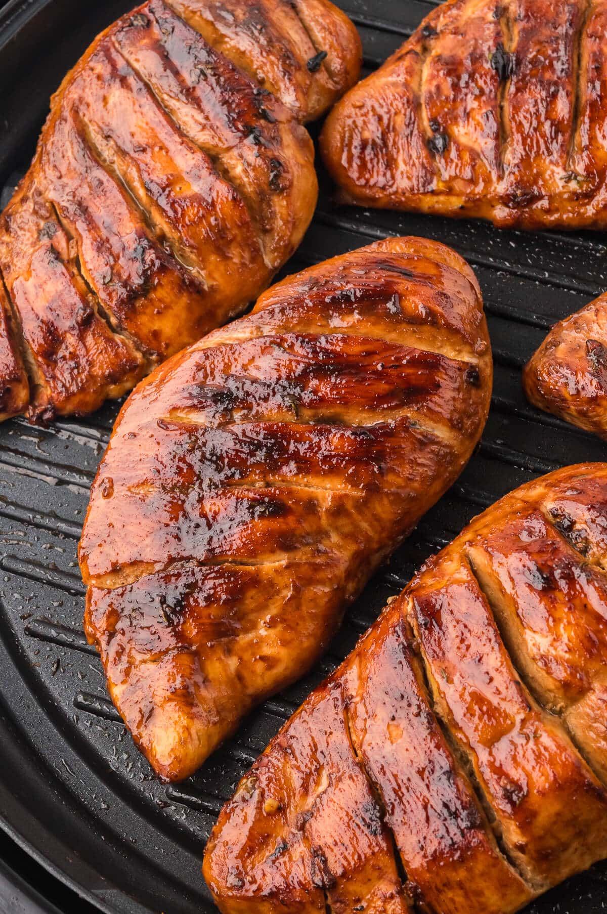 Maple dijon grilled chicken on a grill.