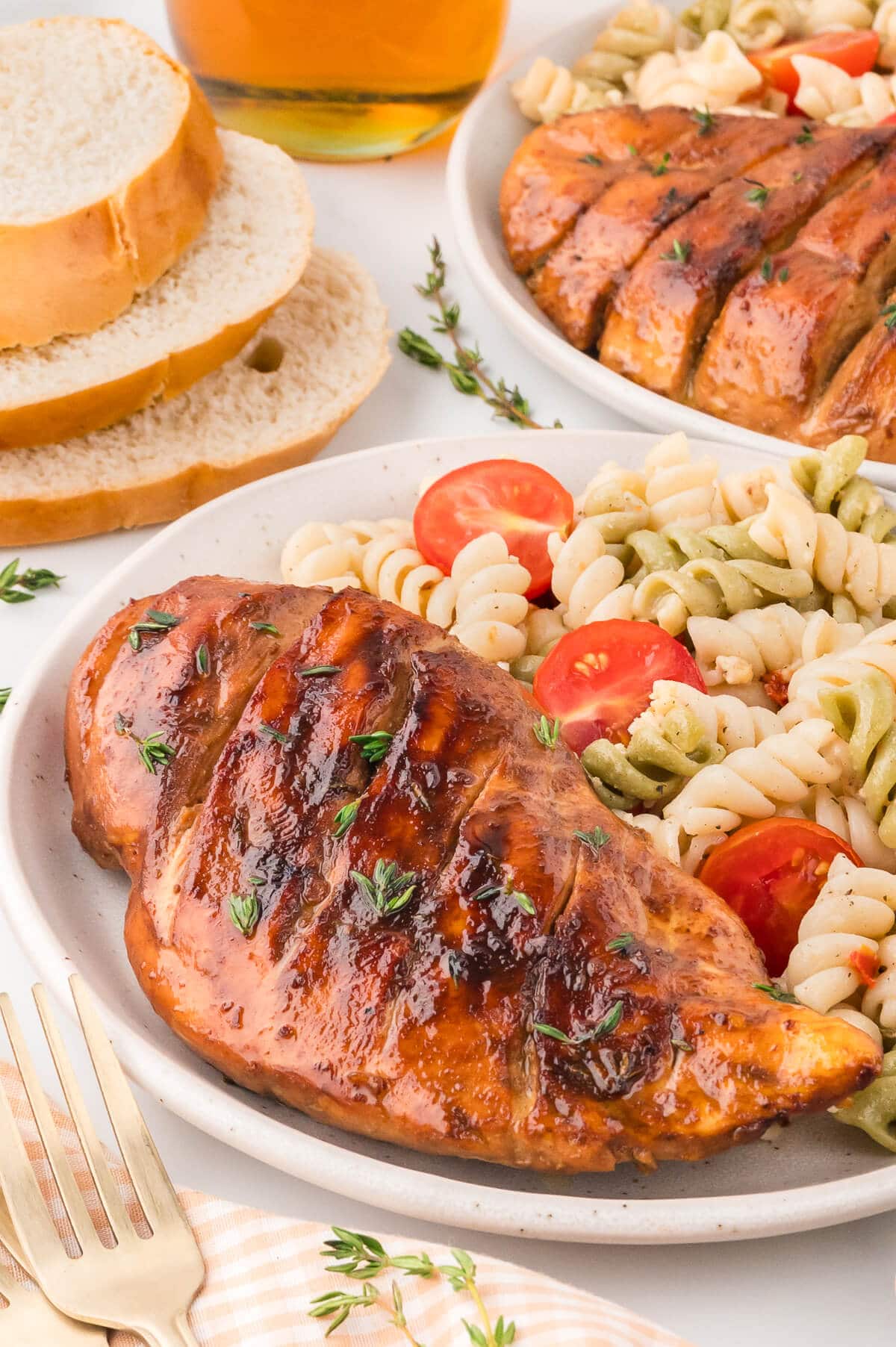 Chicken on a plate with pasta salad.