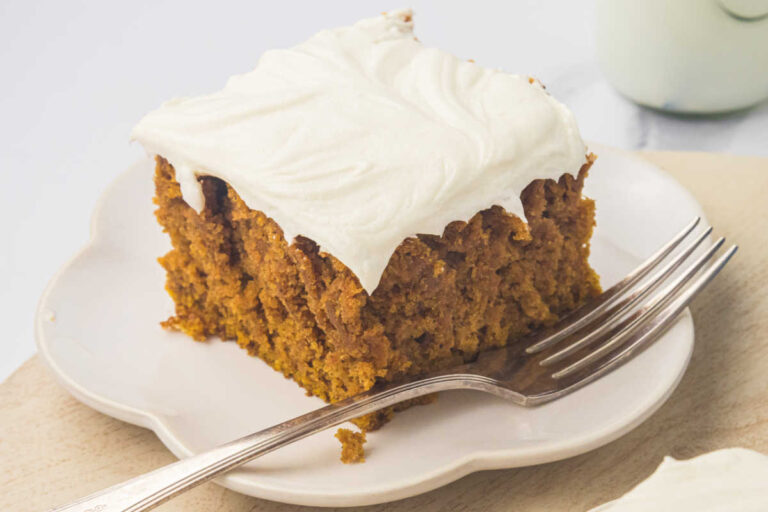 A piece of cake on a plate with a fork.
