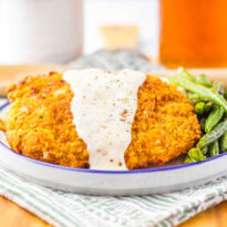 The recipe on a plate with green beans.