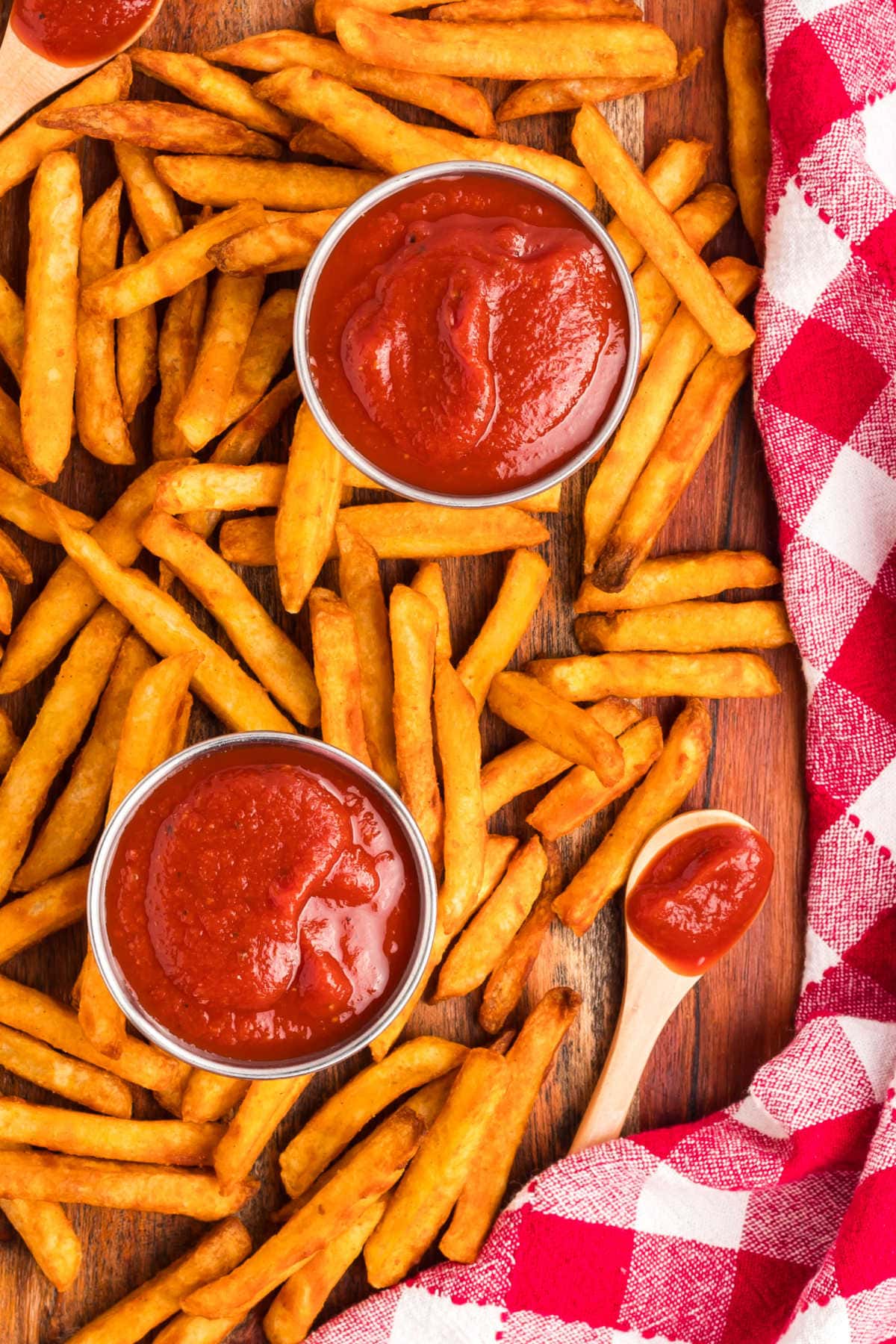 French fries on a wooden cutting board with the recipe.