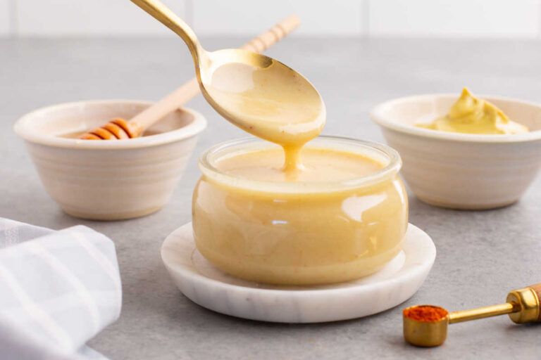A spoon drizzling the recipe in a jar.
