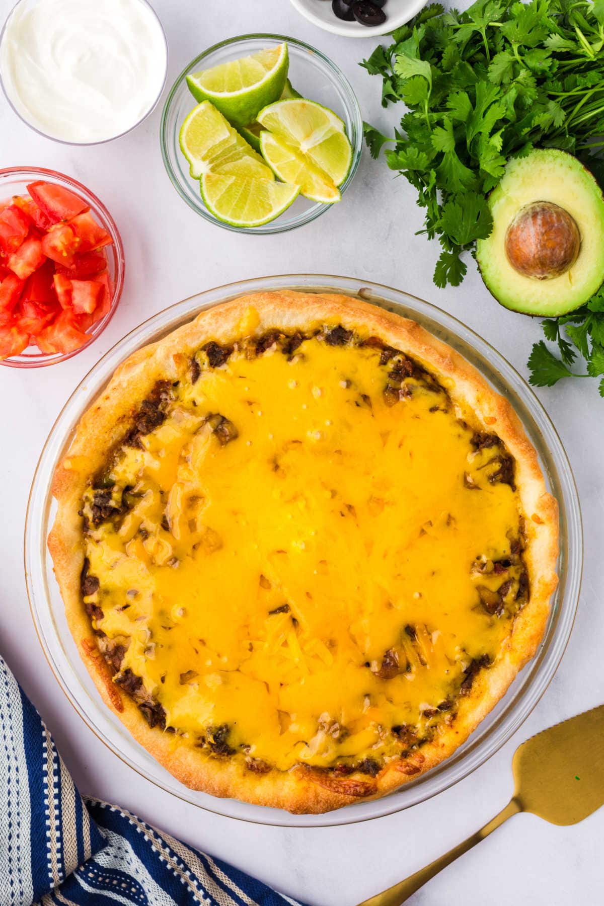 Taco pie surrounded by ingredients.