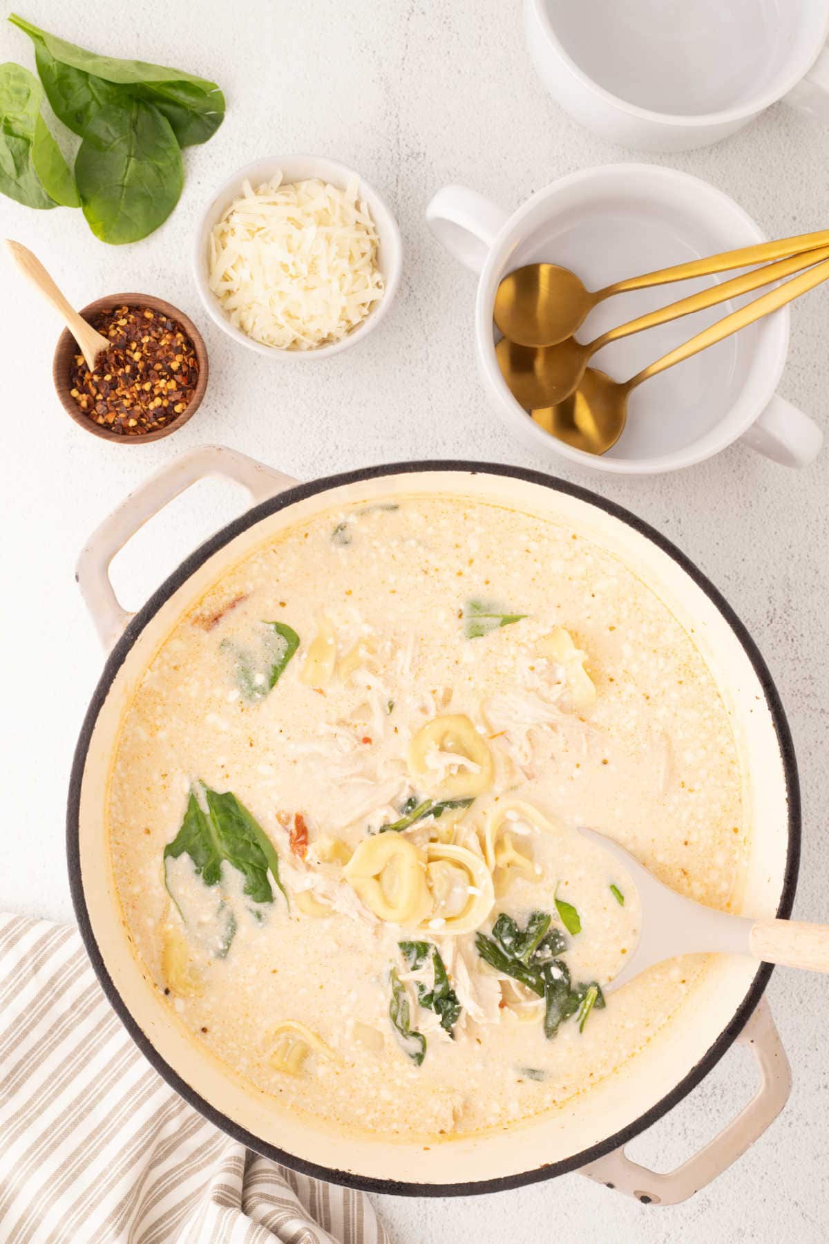 A pot of soup with a ladle.