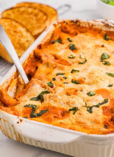 The recipe in a pan with a serving spoon in it.