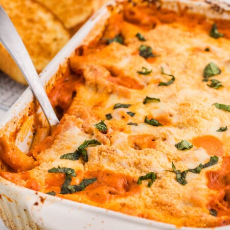 The recipe in a pan with a serving spoon in it.