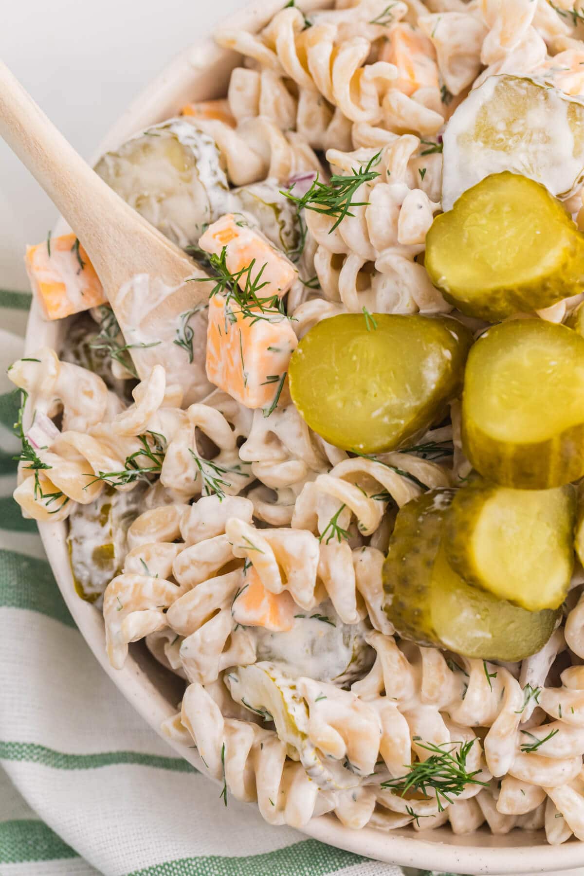 A bowl of the recipe with a wooden spoon in it.
