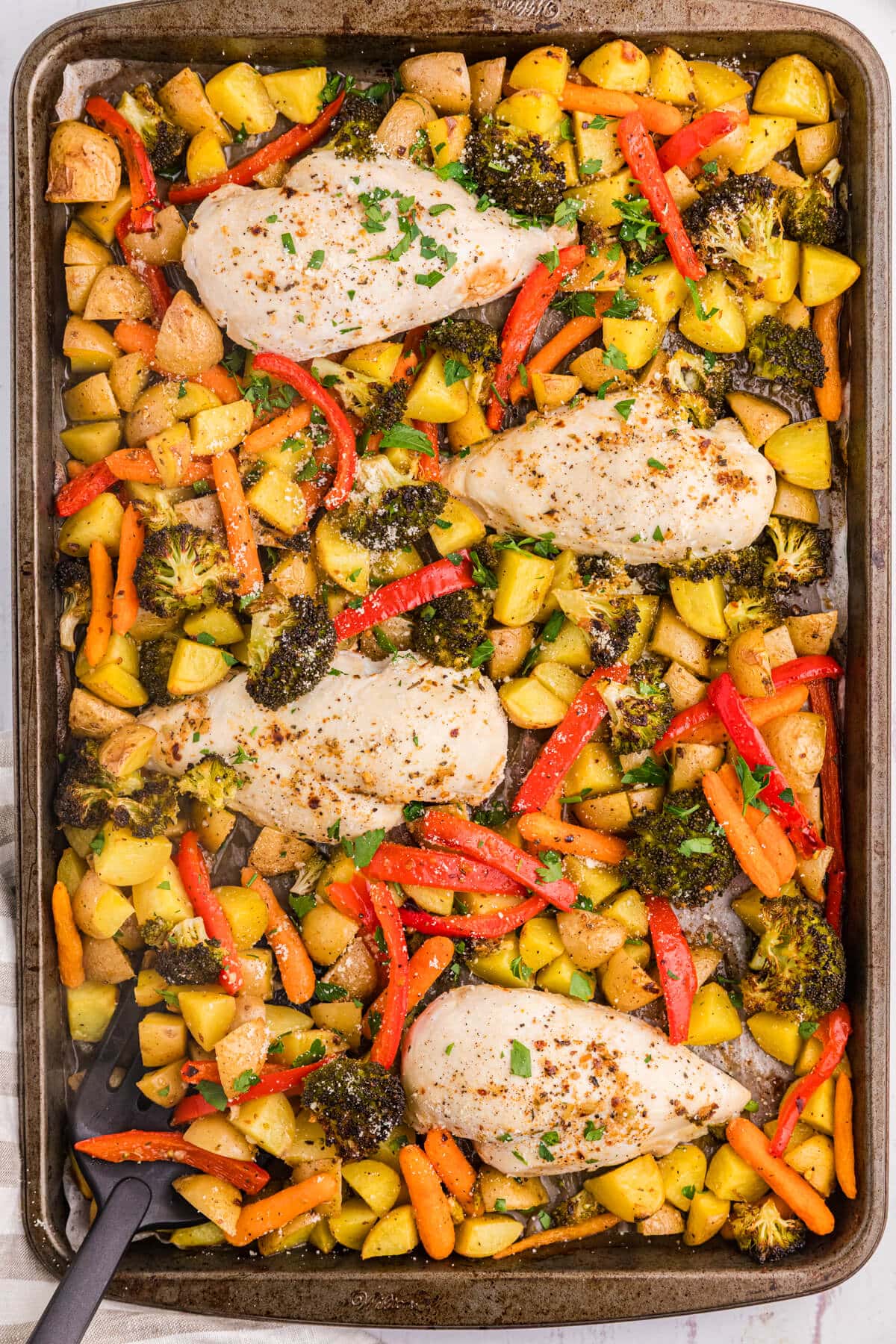 A sheet pan with Garlic Butter Chicken and Veggies.