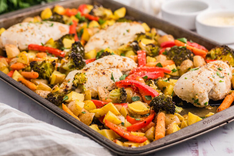 A sheet pan with chicken, vegetables and potatoes