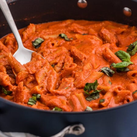 The recipe in a skillet with a serving spoon.
