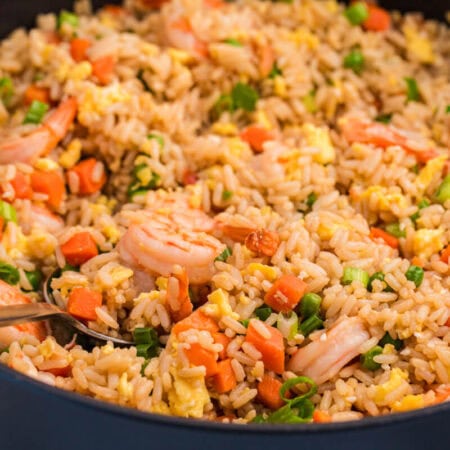 A pan filled with fried rice and shrimp.