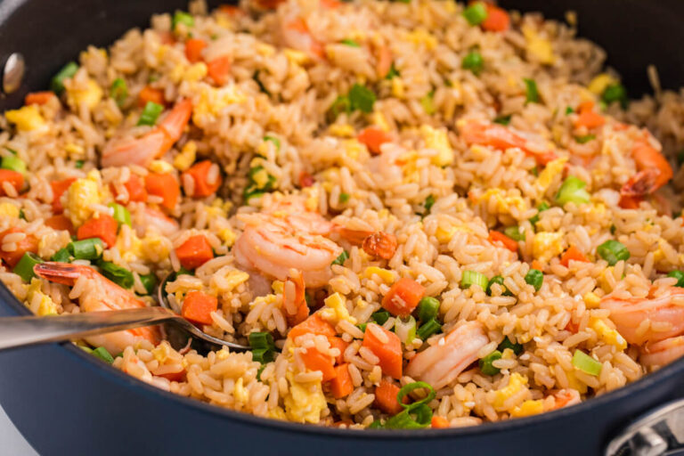 A pan filled with fried rice and shrimp.