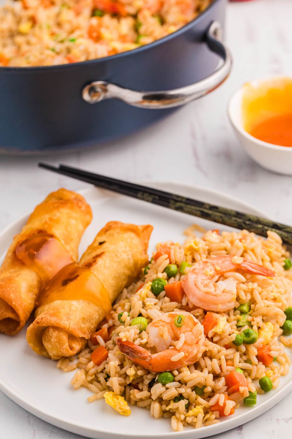 The recipe on a plate with spring rolls.