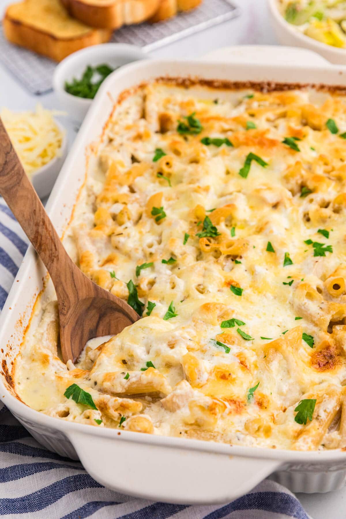 The recipe in a pan with a wooden serving spoon.