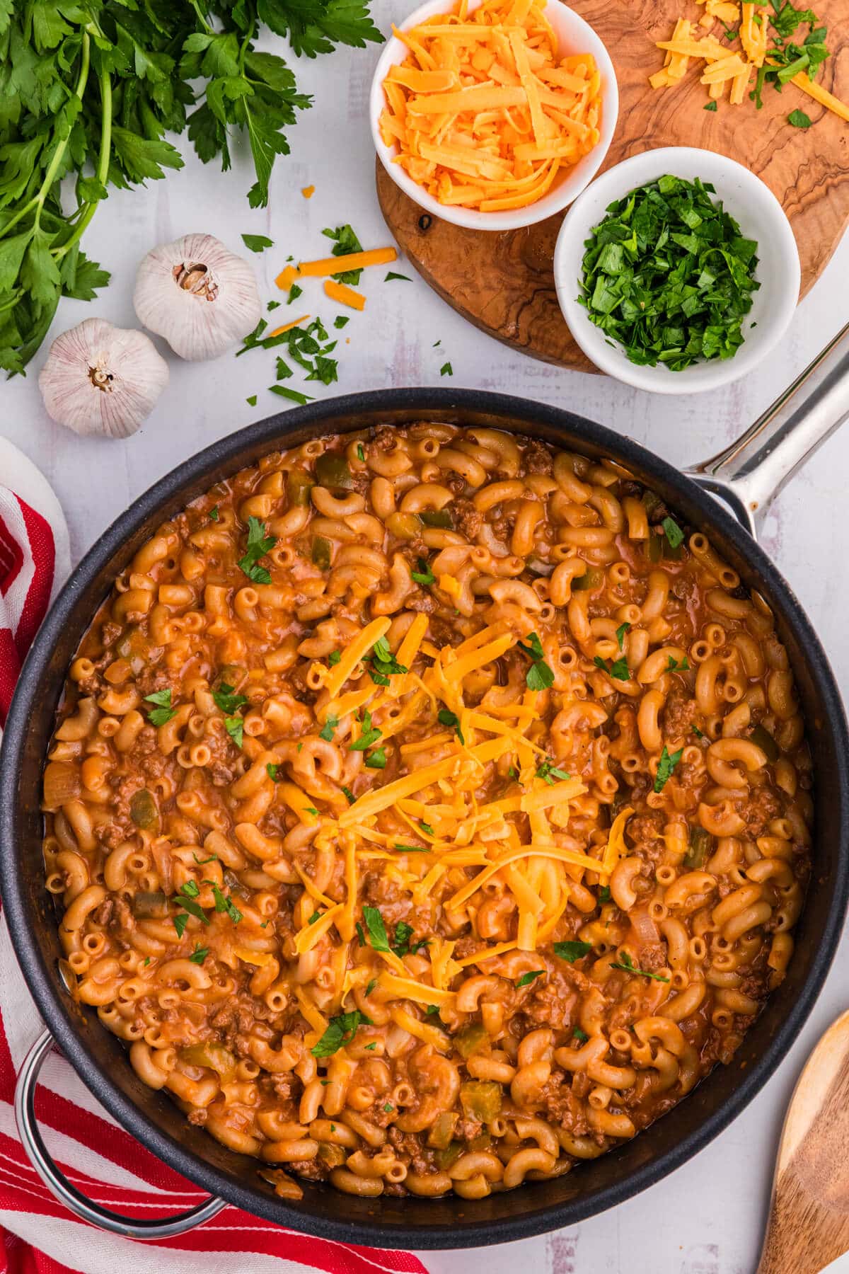 Sloppy Joe Mac and Cheese in a skillet surrounded by ingredients.