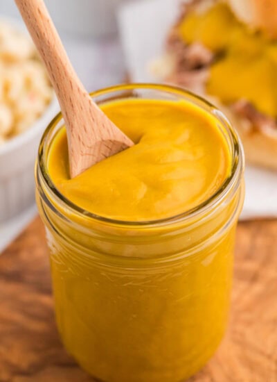 A jar of the recipe with a wooden spoon.